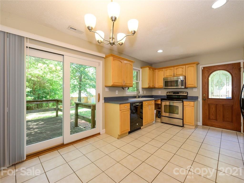 513 West Rebound Road Lancaster, SC 29720 - Photo 8 of 31 a kitchen with stainless steel appliances granite countertop a stove top oven a sink dishwasher and a refrigerator with wooden floor