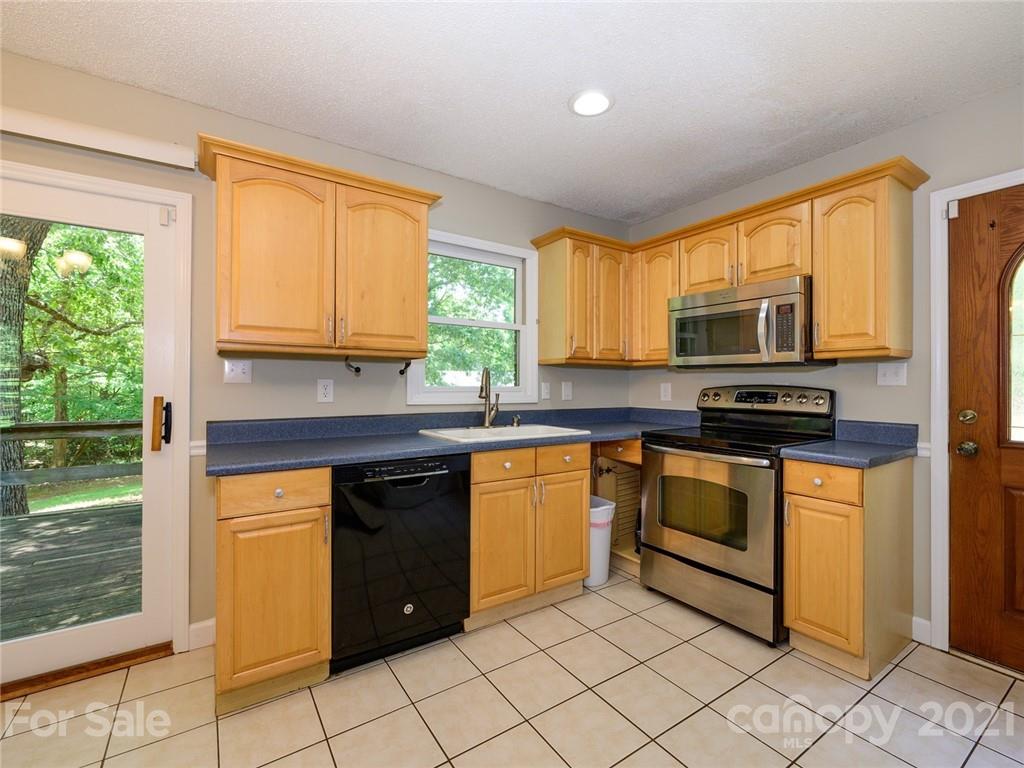 513 West Rebound Road Lancaster, SC 29720 - Photo 9 of 31 a kitchen with stainless steel appliances granite countertop a stove top oven a sink dishwasher and granite counter tops