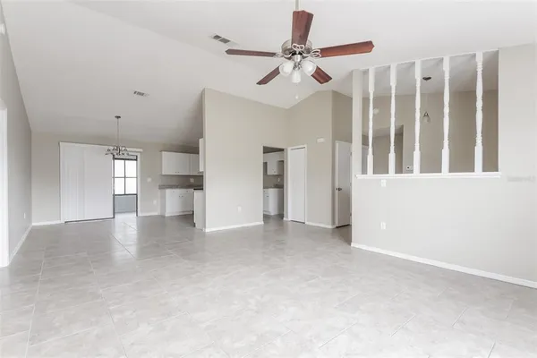 a view of a livingroom with wooden floor and a ceiling fan