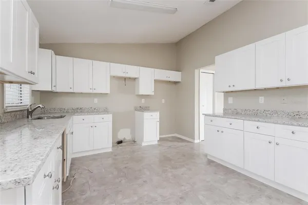 a kitchen with cabinets appliances and a counter space