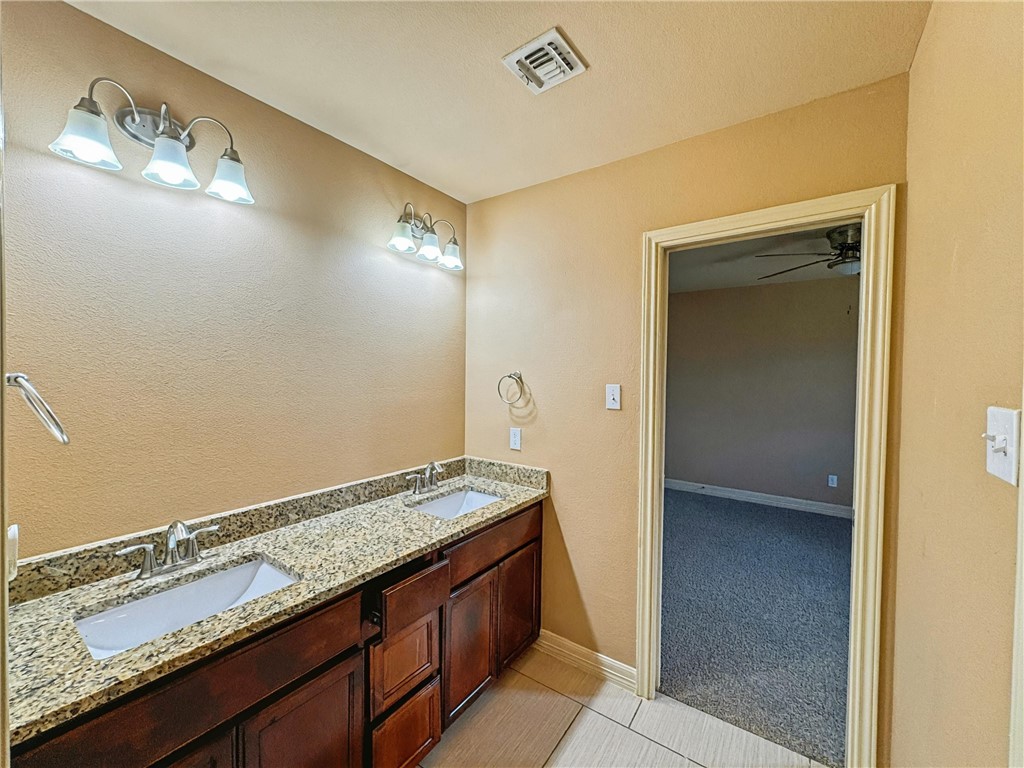 1832 Bay Landing Drive Portland, TX 78374 - Photo 25 of 29 a view of spacious bathroom with a granite countertop sink and a mirror