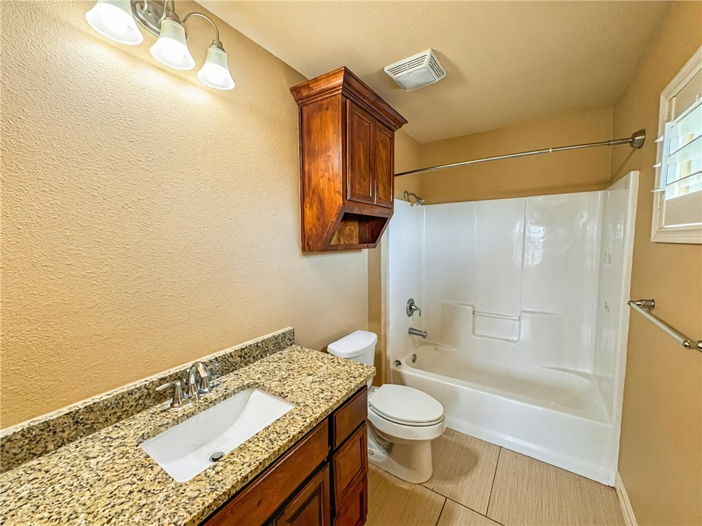 1832 Bay Landing Drive Portland, TX 78374 - Photo 26 of 29 a bathroom with a granite countertop sink toilet and shower