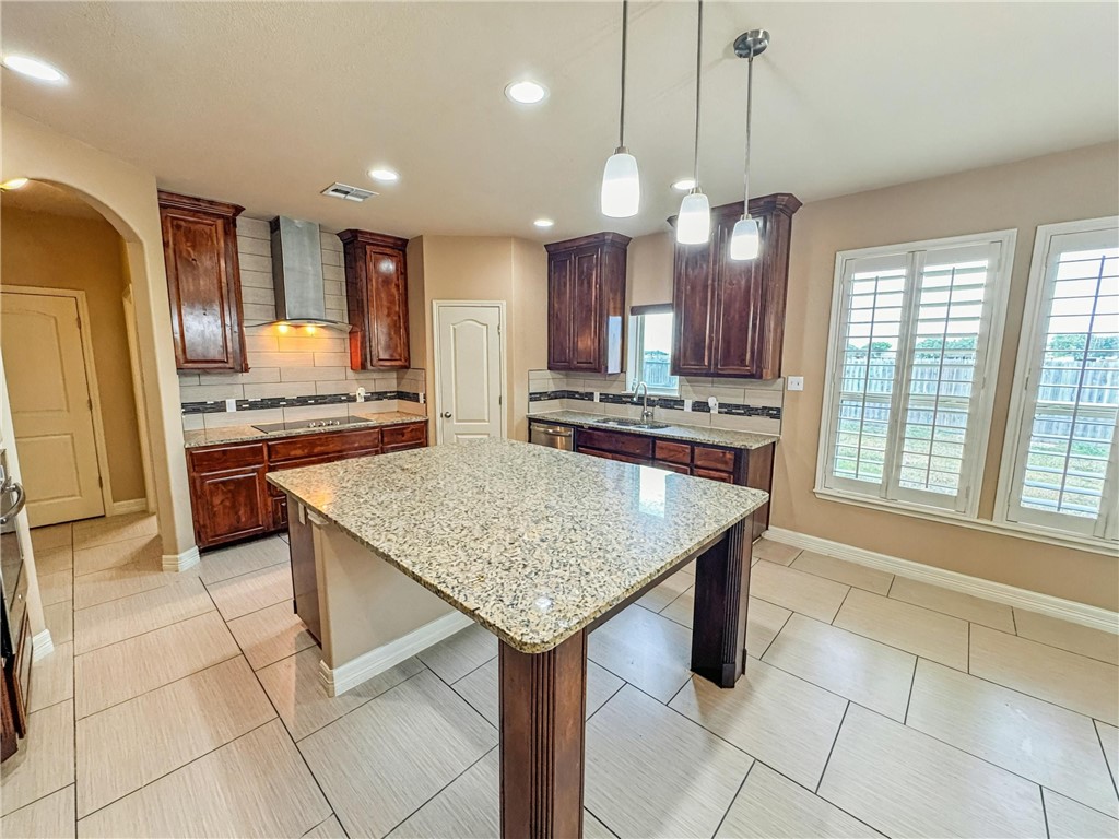 1832 Bay Landing Drive Portland, TX 78374 - Photo 9 of 29 a kitchen with stainless steel appliances granite countertop a sink a stove a refrigerator and island