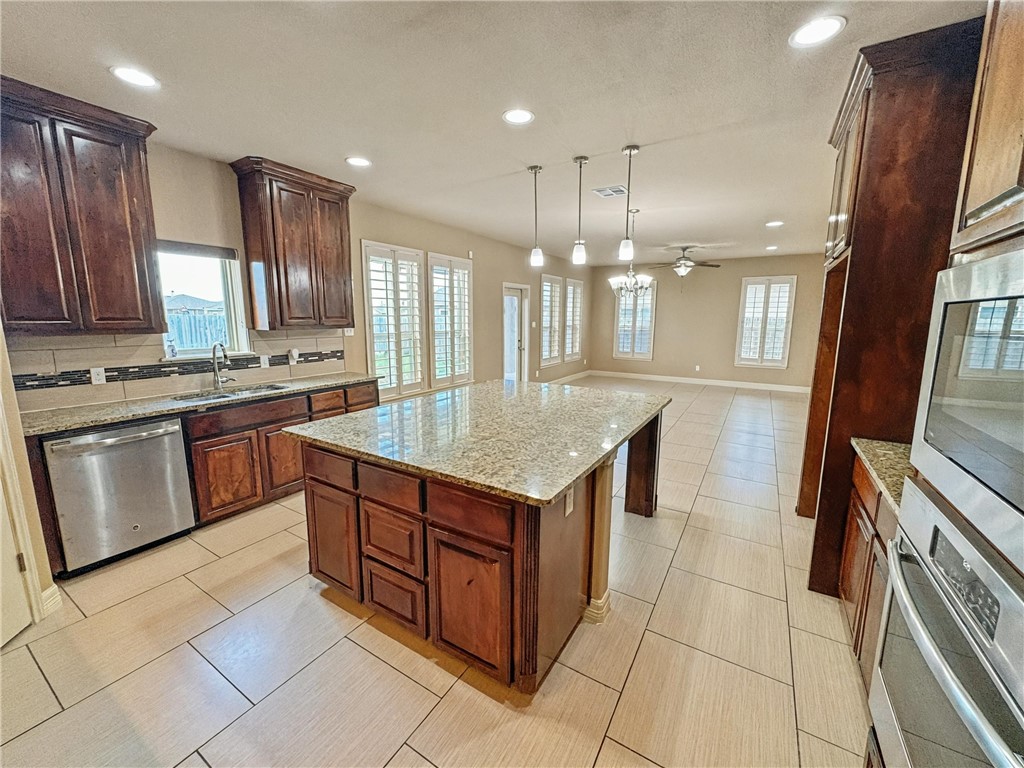 1832 Bay Landing Drive Portland, TX 78374 - Photo 10 of 29 a kitchen with a stove sink and a refrigerator