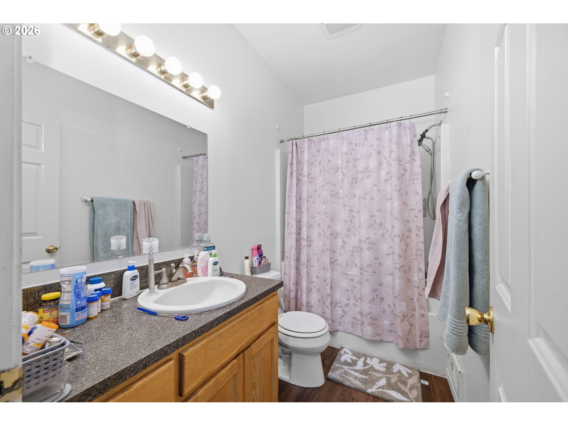 87851 Cedar Flat Road Springfield, OR 97478 - Photo 9 of 23 a bathroom with a granite countertop sink a toilet a mirror a vanity and shower