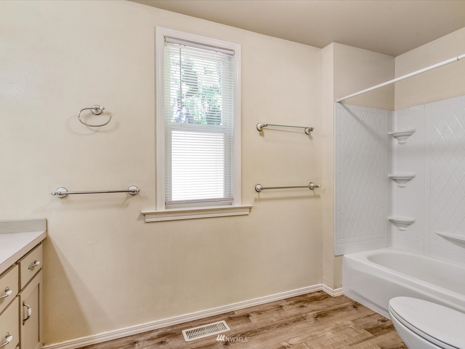 97 Logan Avenue South Renton, WA 98057 - Photo 12 of 32 a bathroom with a granite countertop sink a toilet and shower