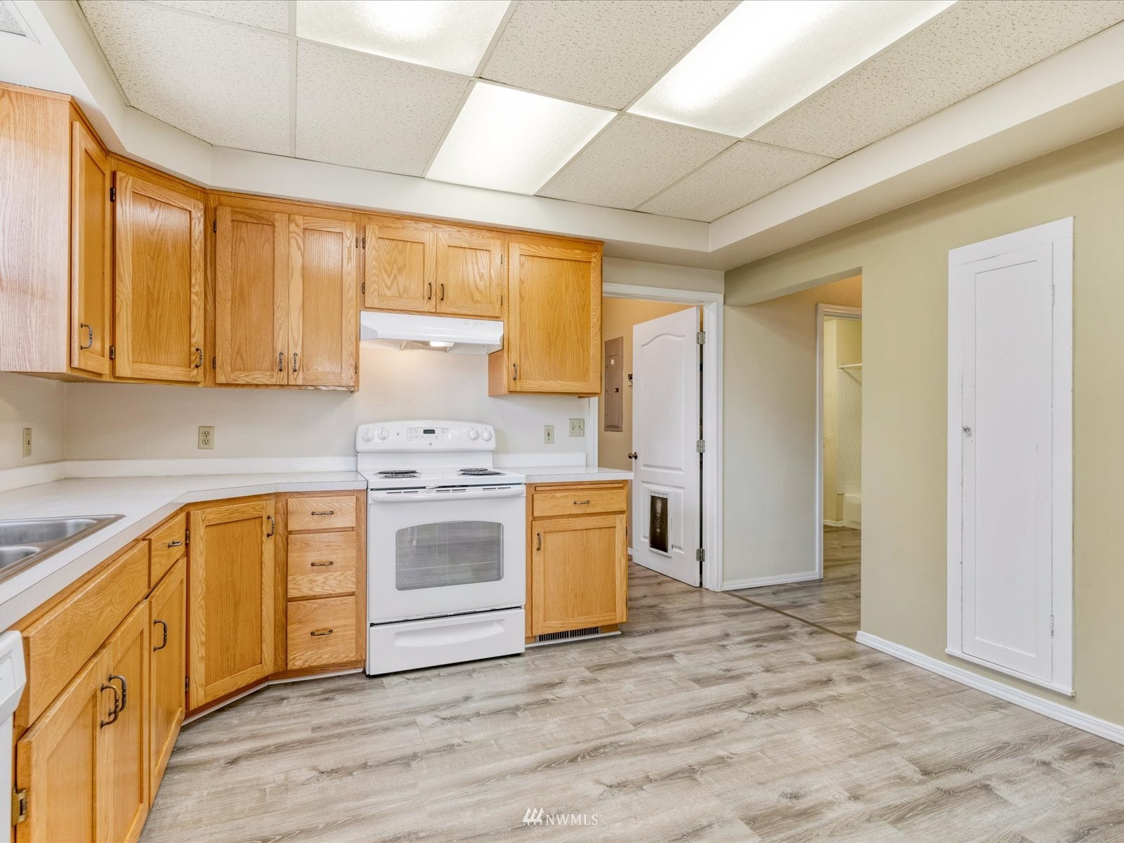 97 Logan Avenue South Renton, WA 98057 - Photo 3 of 32 a kitchen with a stove a sink and a refrigerator