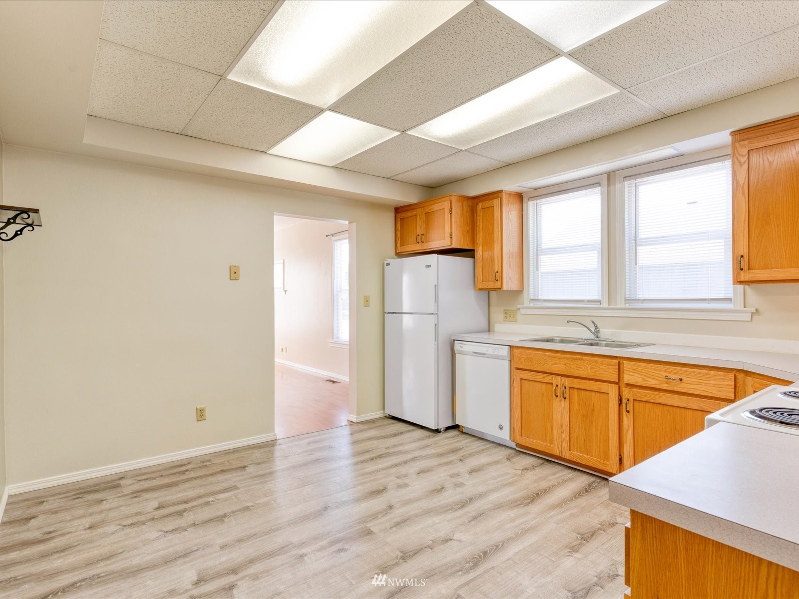 97 Logan Avenue South Renton, WA 98057 - Photo 5 of 32 a view of a kitchen with a sink and wooden floor