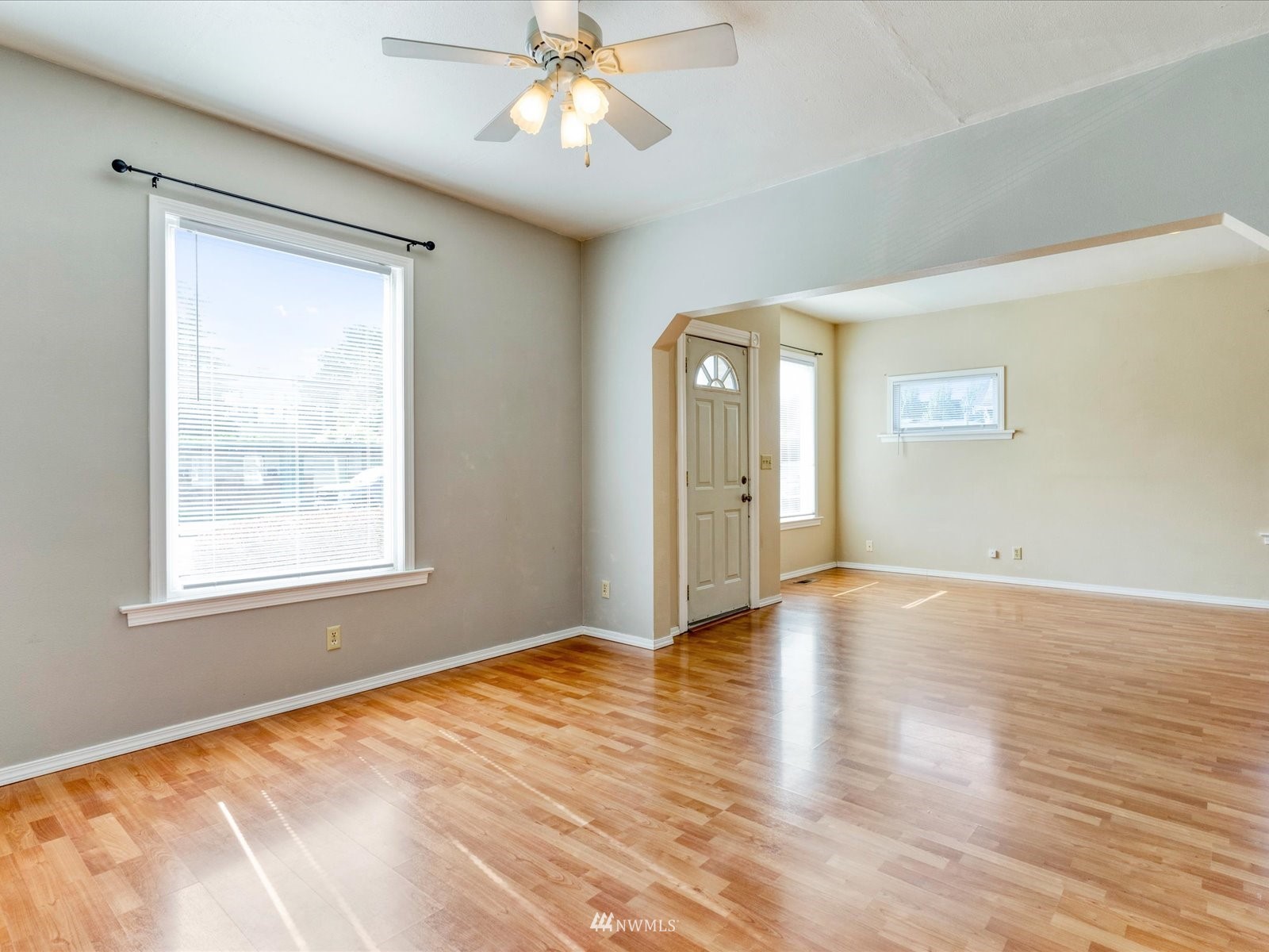 97 Logan Avenue South Renton, WA 98057 - Photo 7 of 32 a view of an empty room with wooden floor and a window