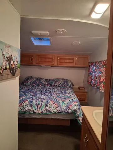 a bed sitting in a bedroom next to a window