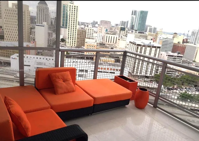 a bedroom with furniture and a large window