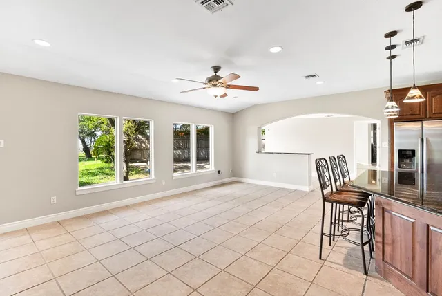 a view of a livingroom with furniture a ceiling fan and window