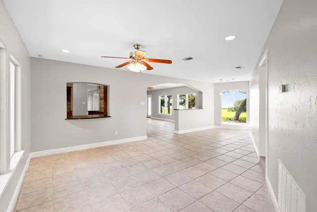 a view of a hallway with wooden floor and a fireplace