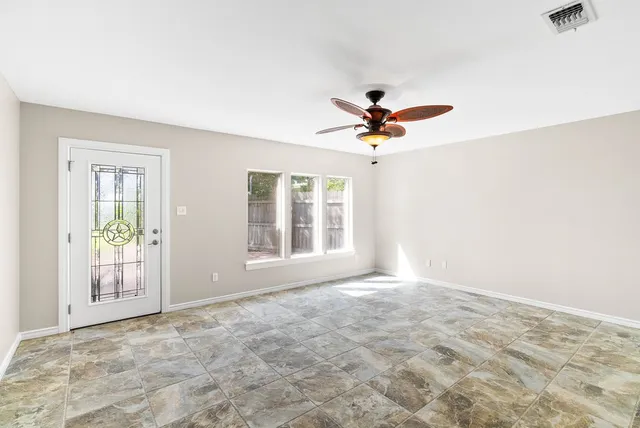 a view of room with window and ceiling fan