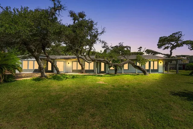 a view of an house with backyard space and garden