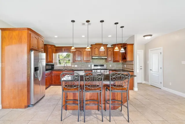 a dining room filled with furniture and a chandelier