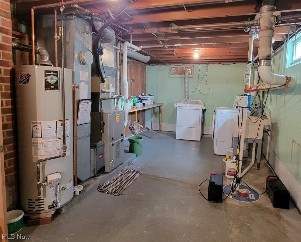 6416 Milan Road Sandusky, OH 44870 - Photo 26 of 34 Basement featuring washer and dryer, brick wall, and gas water heater