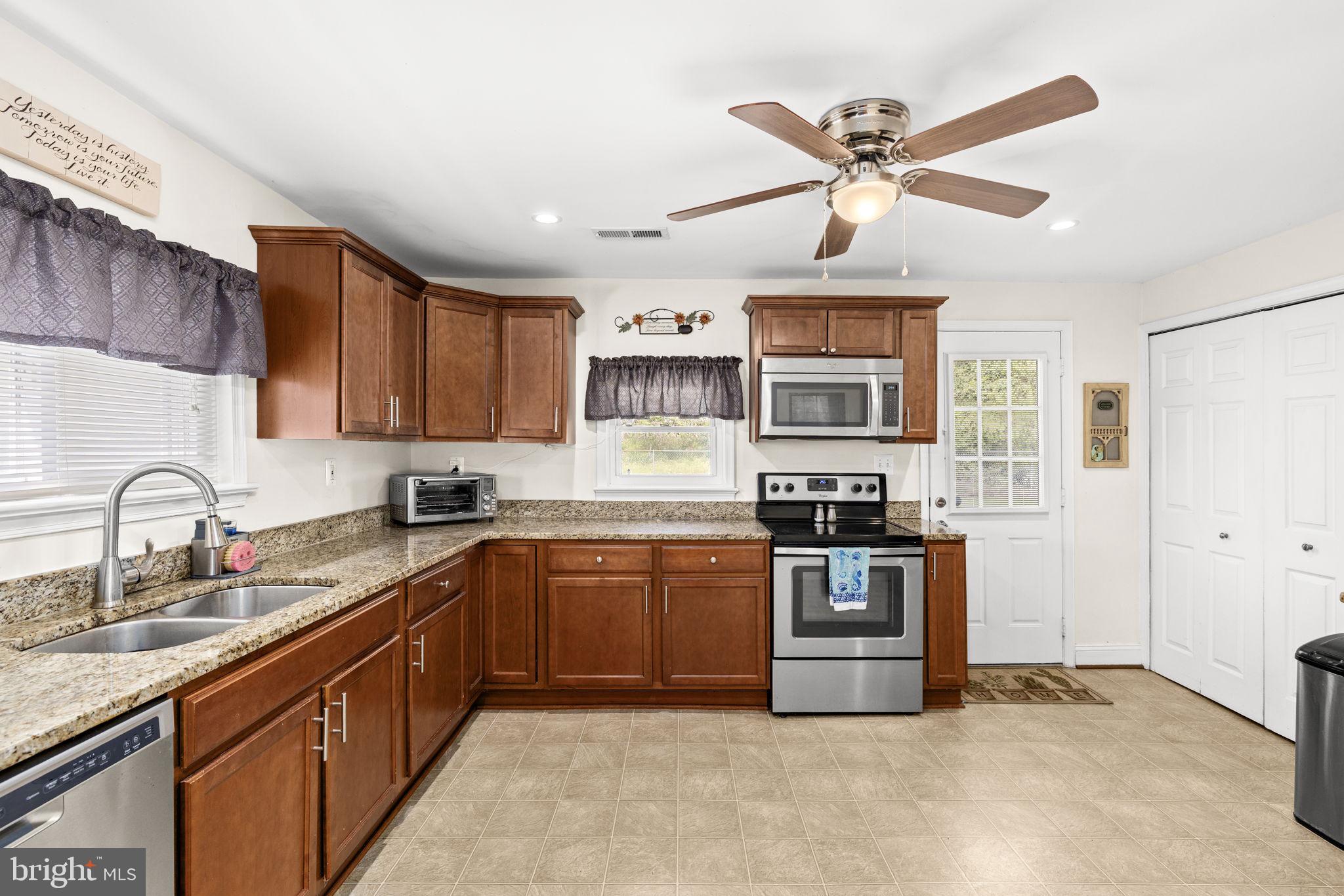 66 Kelley Road Fredericksburg, VA 22405 - Photo 11 of 35 a kitchen with stainless steel appliances granite countertop a stove sink and cabinets
