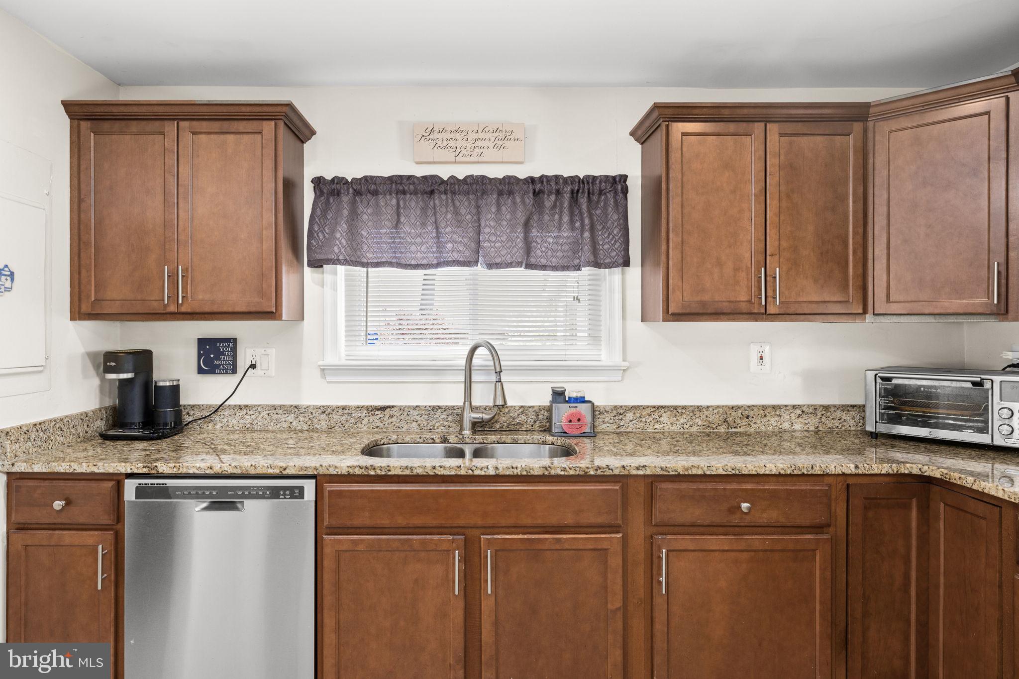 66 Kelley Road Fredericksburg, VA 22405 - Photo 14 of 35 a kitchen with stainless steel appliances granite countertop a sink stove and cabinets