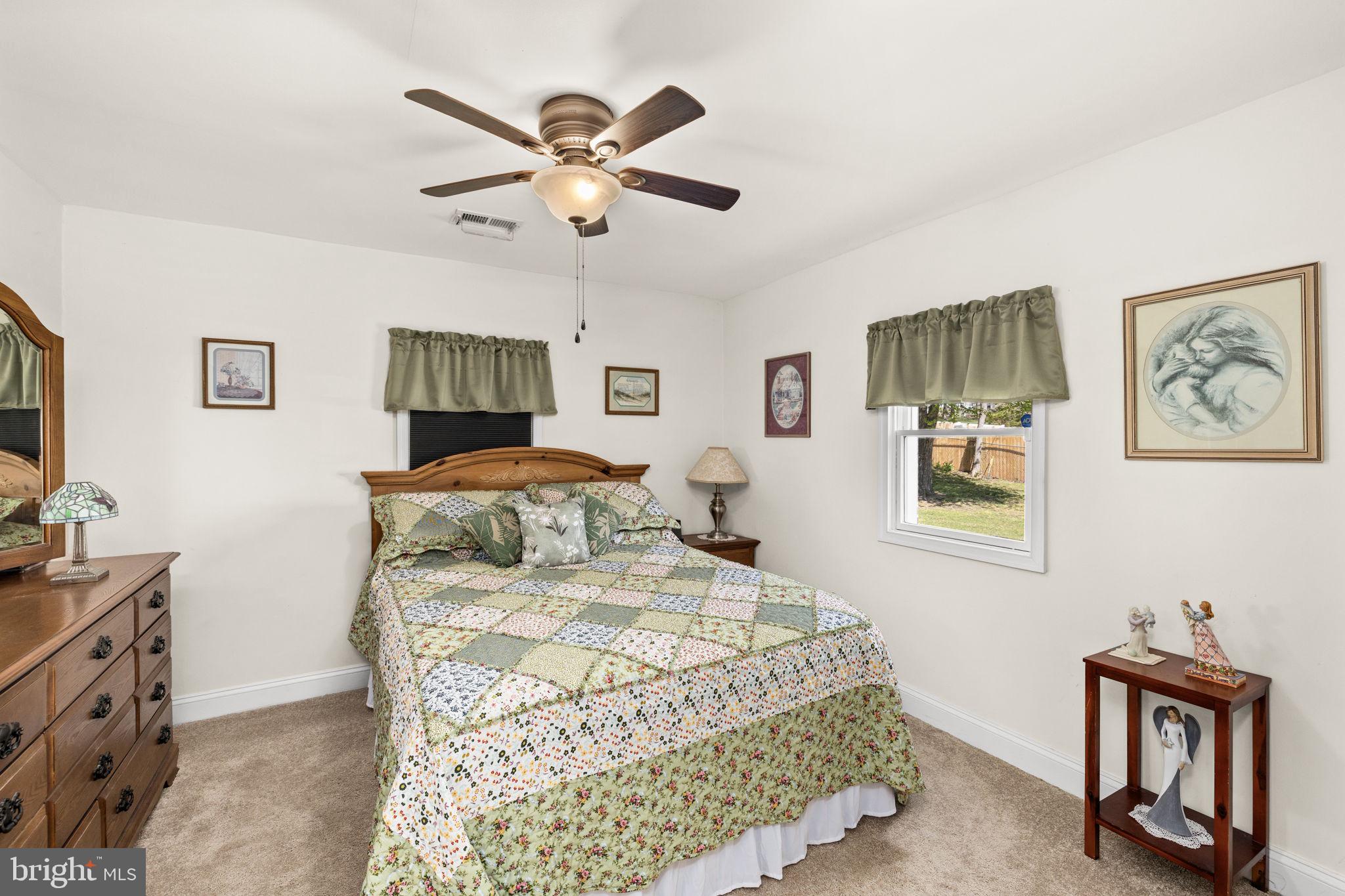 66 Kelley Road Fredericksburg, VA 22405 - Photo 17 of 35 a bedroom with a bed and a chandelier