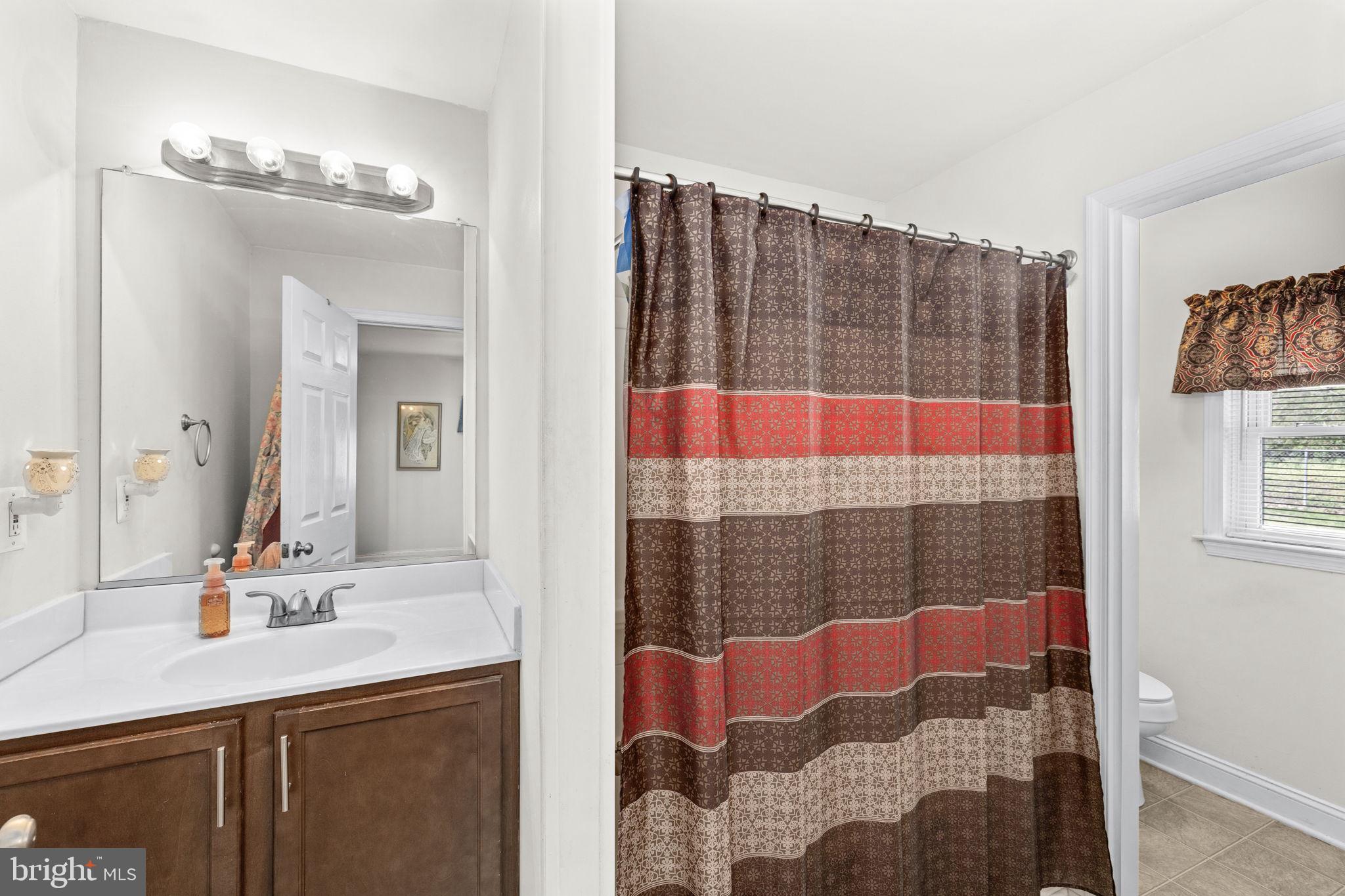 66 Kelley Road Fredericksburg, VA 22405 - Photo 18 of 35 a bathroom with a sink vanity and shower