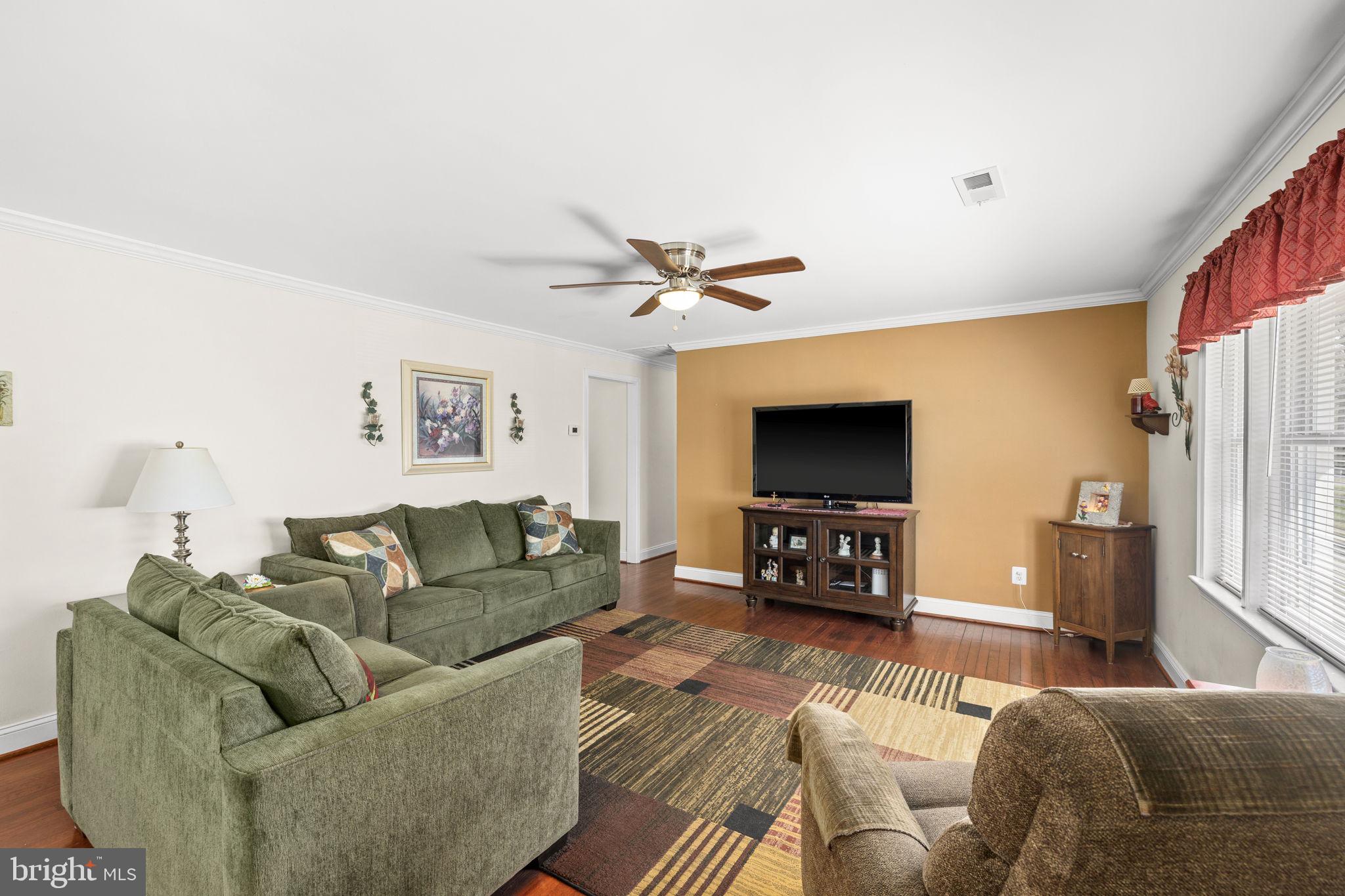 66 Kelley Road Fredericksburg, VA 22405 - Photo 7 of 35 a living room with furniture and a flat screen tv with wooden floor