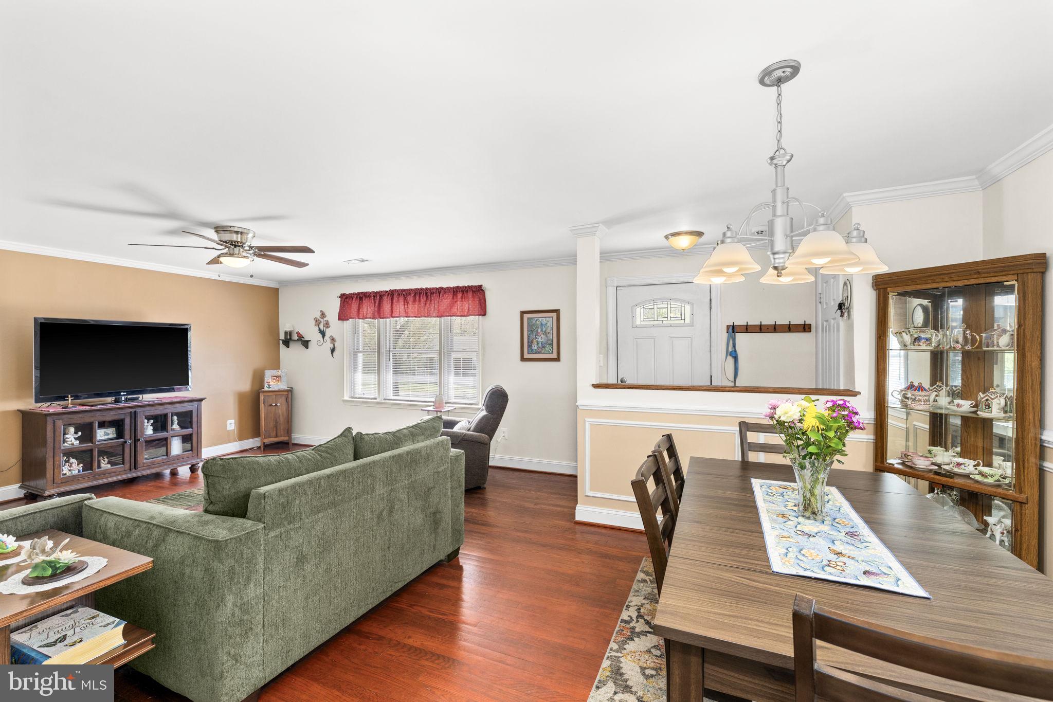 66 Kelley Road Fredericksburg, VA 22405 - Photo 9 of 35 a living room with furniture a flat screen tv and a chandelier
