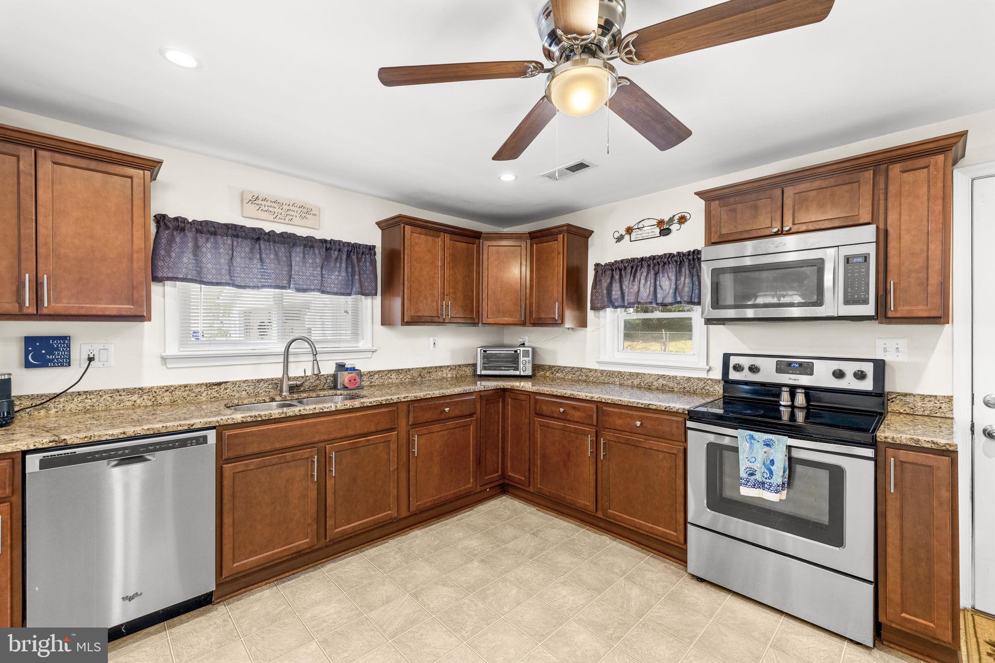 66 Kelley Road Fredericksburg, VA 22405 - Photo 10 of 35 a kitchen with stainless steel appliances granite countertop a sink and stove top oven