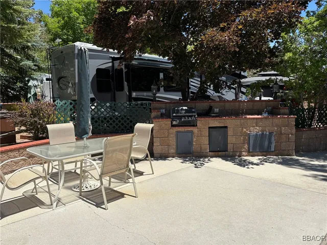 a view of a patio with table and chairs and potted plants