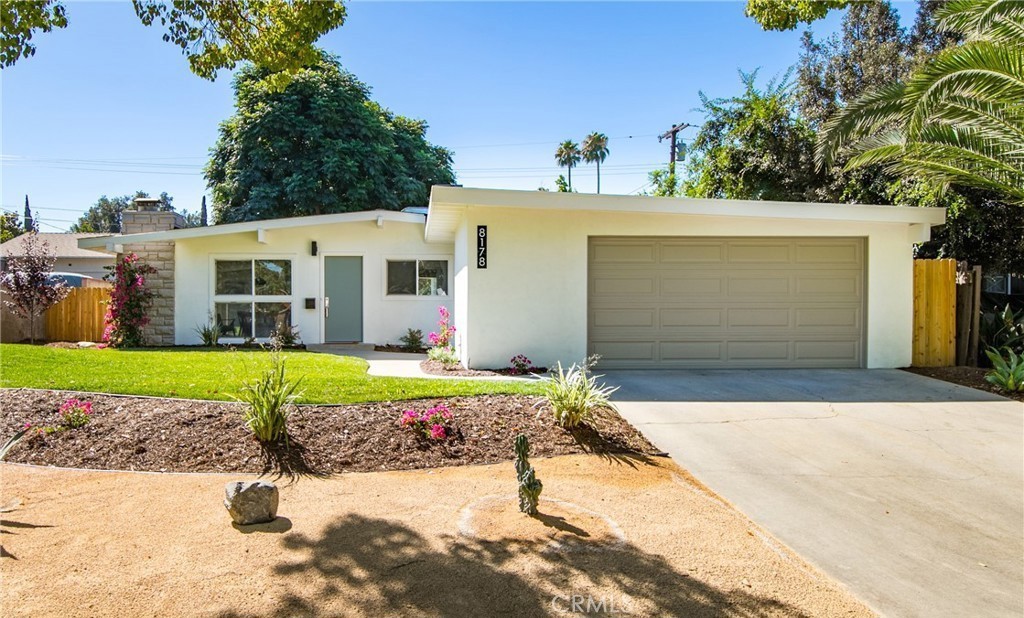 8178 Buckingham Place Riverside, CA 92504 - Photo 1 of 1 a front view of a house with a yard and garage