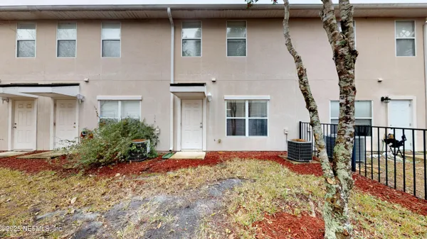 a house that has a large tree in front of it