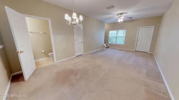 an empty room with windows and hardwood floor