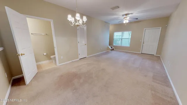 an empty room with windows and hardwood floor
