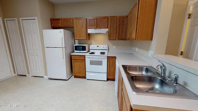 a kitchen with a refrigerator sink and stove
