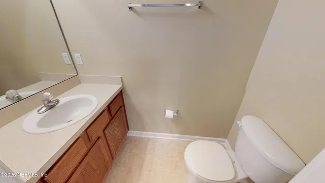 a bathroom with a sink a toilet and mirror