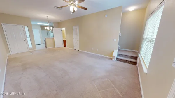 a view of an empty room with a window