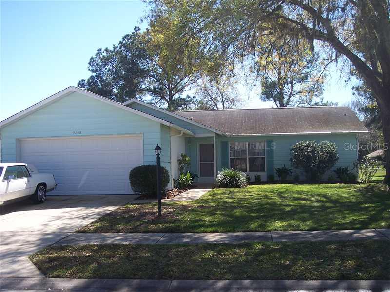 9200 Tiara Court New Port Richey, FL 34655 - Photo 1 of 1 a front view of a house with garden