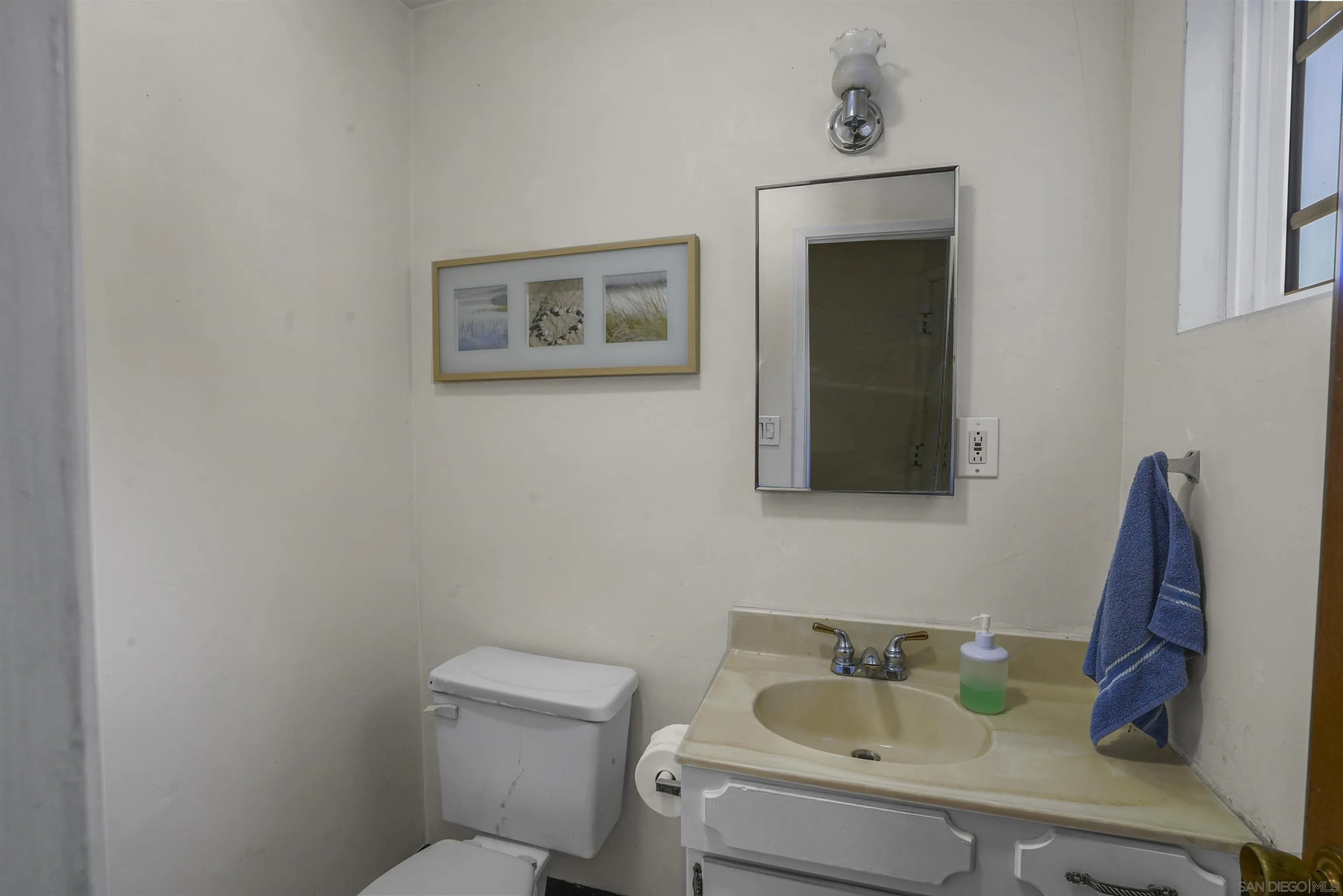 5785 Jackson Drive La Mesa, CA 91942 - Photo 13 of 20 a bathroom with a toilet sink and mirror