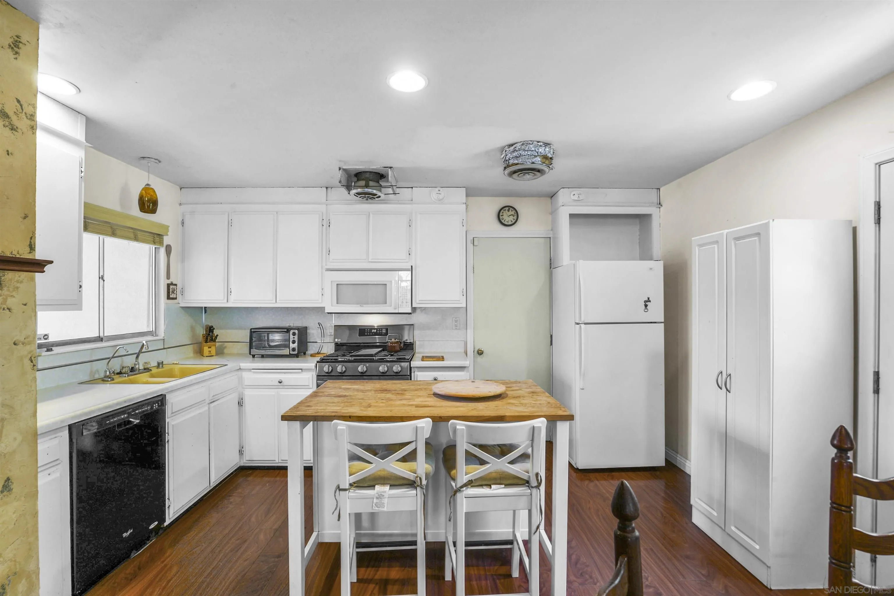 5785 Jackson Drive La Mesa, CA 91942 - Photo 2 of 20 a kitchen with a table chairs refrigerator and cabinets