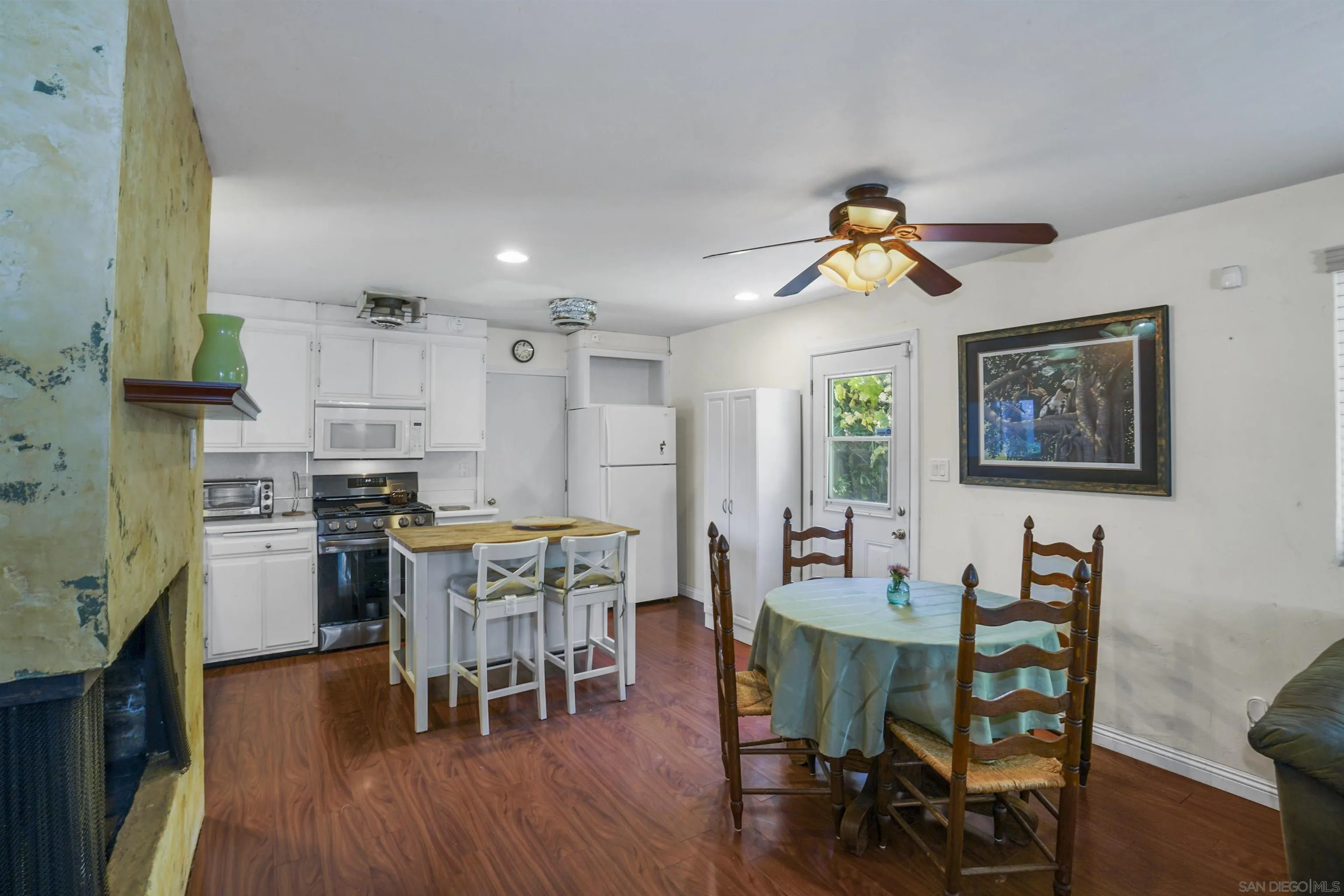 5785 Jackson Drive La Mesa, CA 91942 - Photo 10 of 20 a kitchen with stainless steel appliances granite countertop a dining table chairs stove refrigerator and cabinets