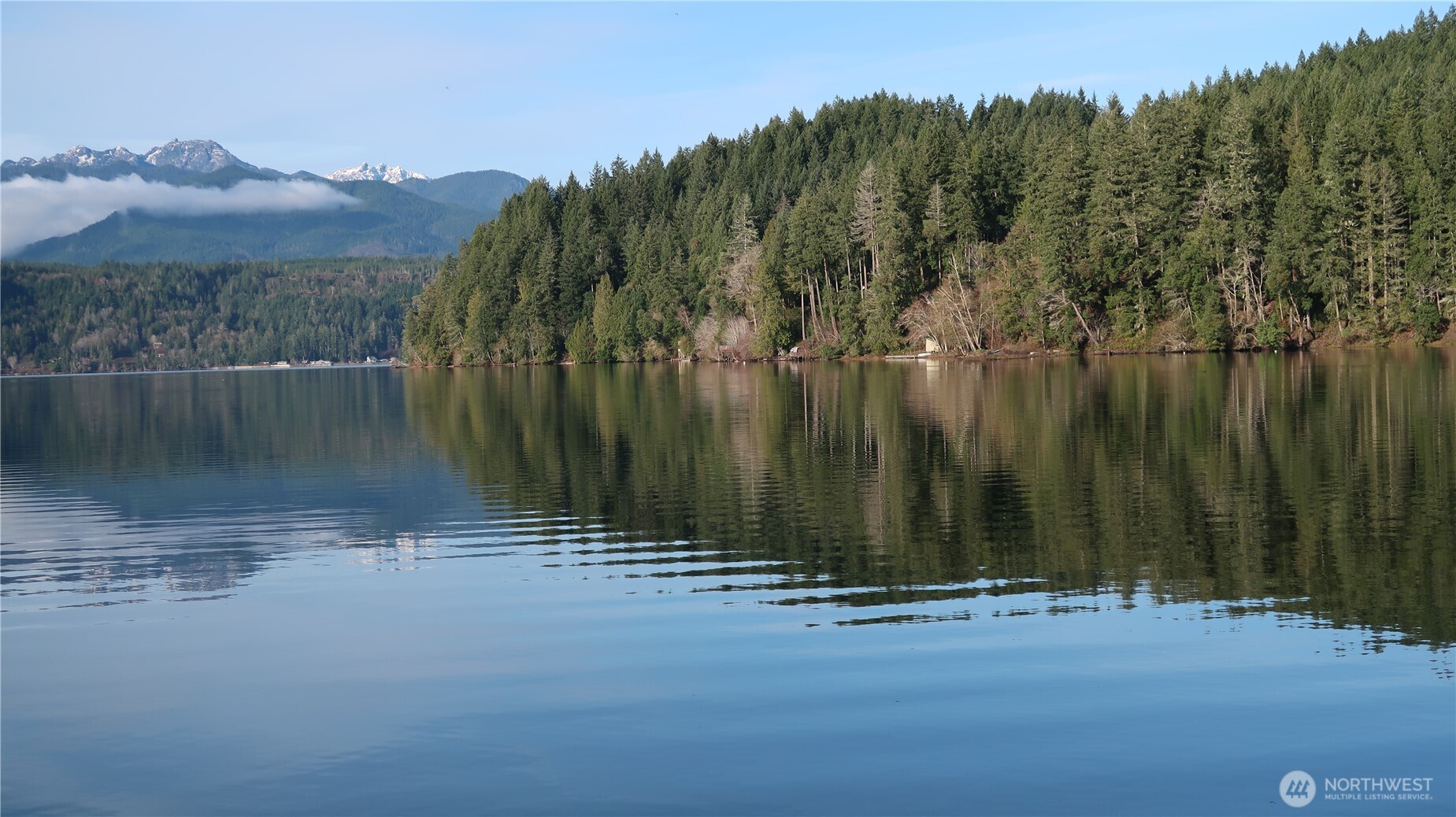 2180 Northeast Holly Dewatto Road Tahuya, WA 98588 - Photo 23 of 30 a view of a water with a building in the background