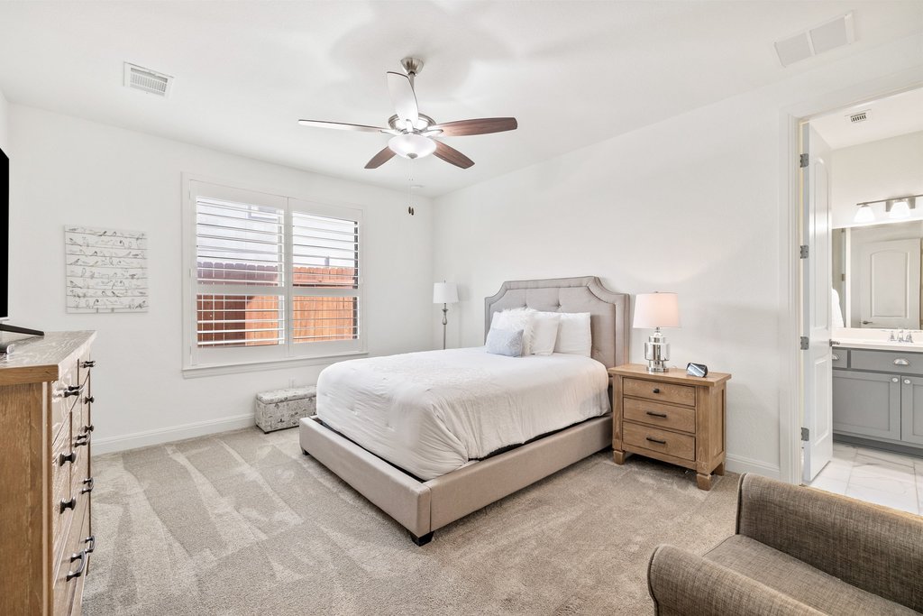 5812 Davenport Divide Road Austin, TX 78738 - Photo 28 of 40 A plush upholstered bed, generous floor space, and direct access to the private bath. Large windows bring in light while maintaining privacy, creating a comfortable and quiet space to unwind.