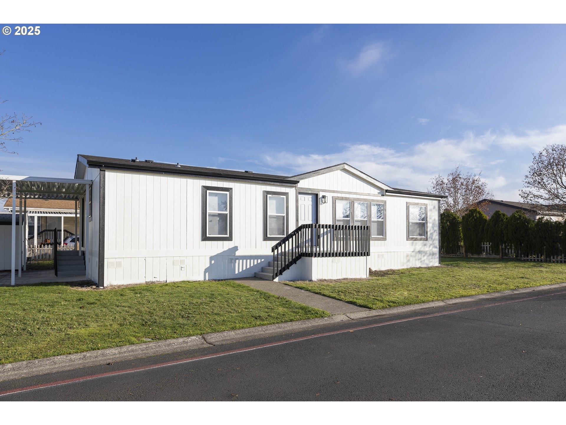 911 York Street, Unit 82 Aumsville, OR 97325 - Photo 1 of 26 a front view of a house with a yard and garage