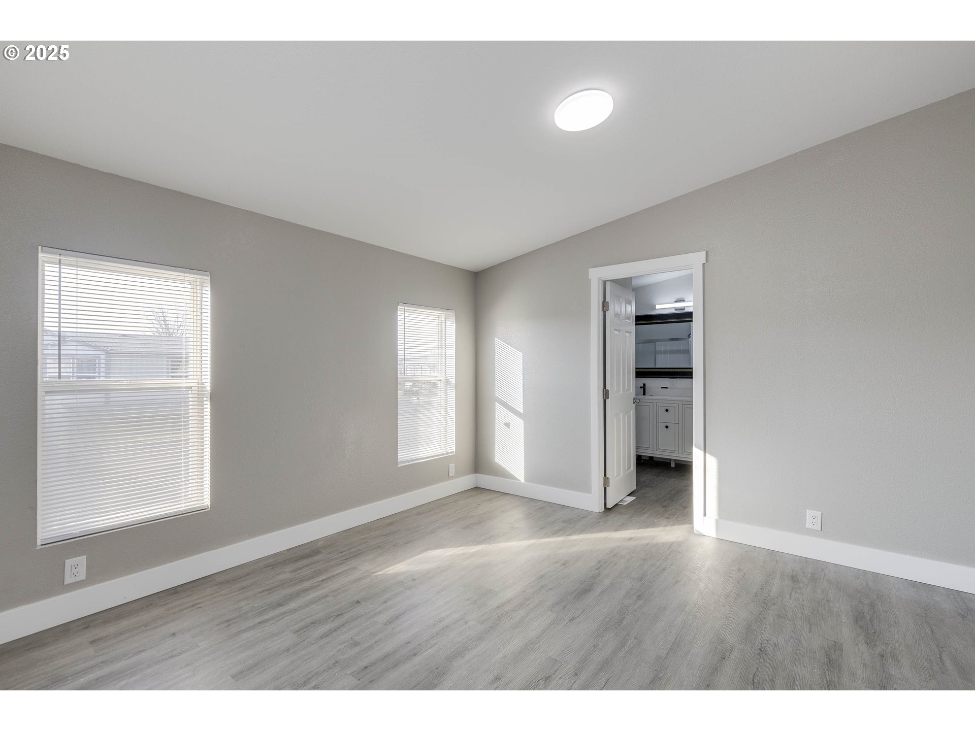 911 York Street, Unit 82 Aumsville, OR 97325 - Photo 13 of 26 a view of an empty room with window and wooden floor