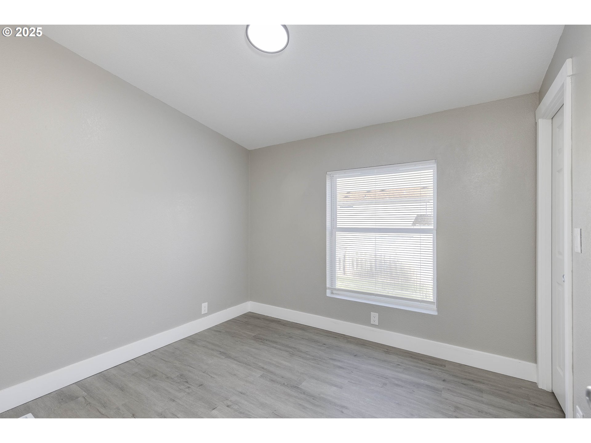 911 York Street, Unit 82 Aumsville, OR 97325 - Photo 18 of 26 a view of an empty room with wooden floor and window