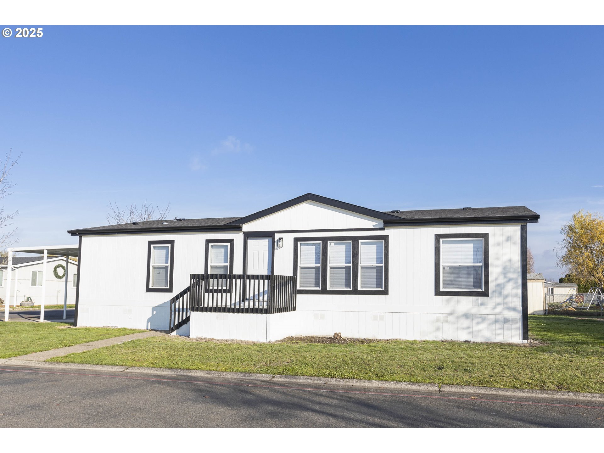 911 York Street, Unit 82 Aumsville, OR 97325 - Photo 3 of 26 a front view of a house with a yard