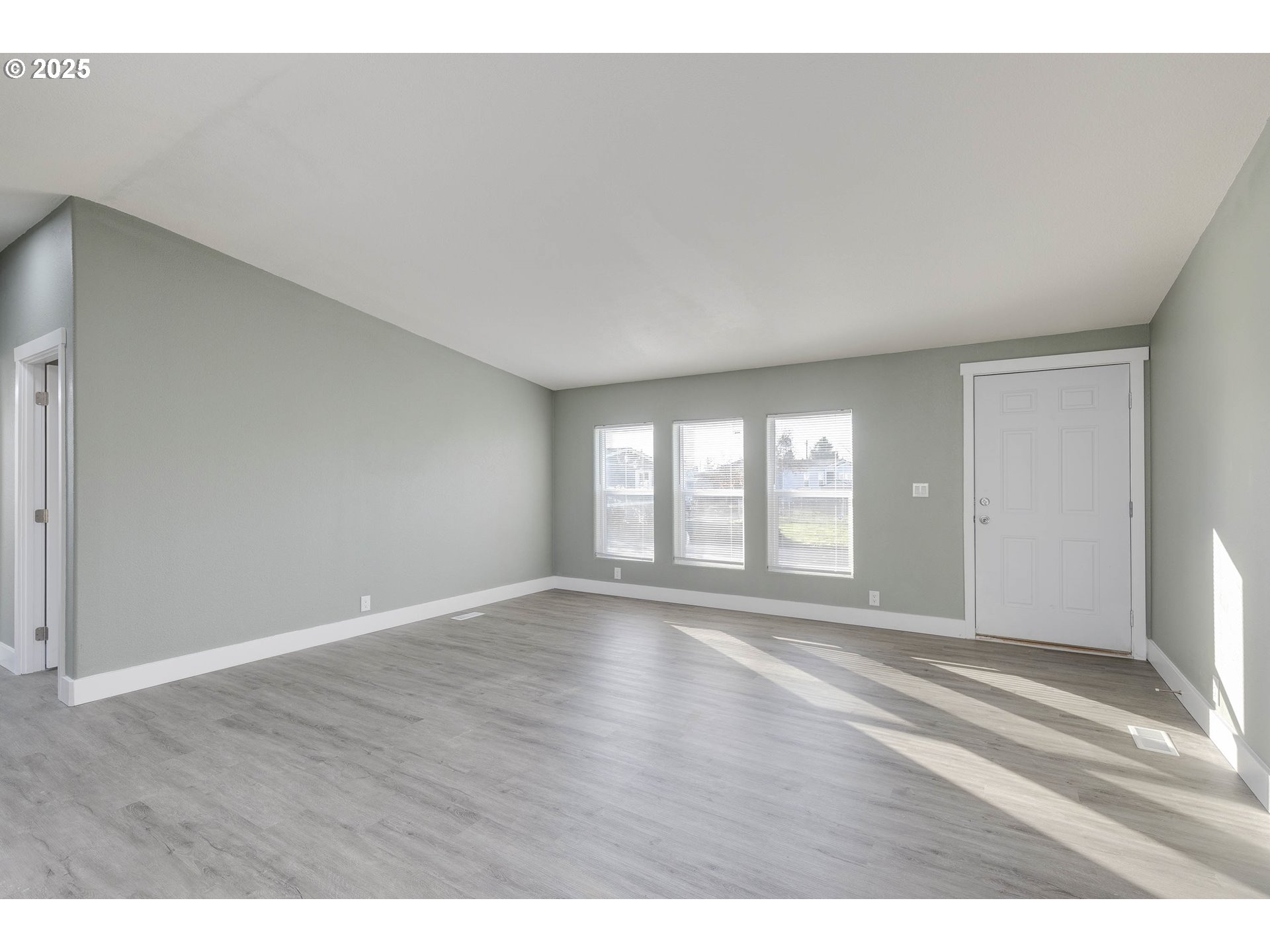 911 York Street, Unit 82 Aumsville, OR 97325 - Photo 5 of 26 a view of an empty room with wooden floor and a window