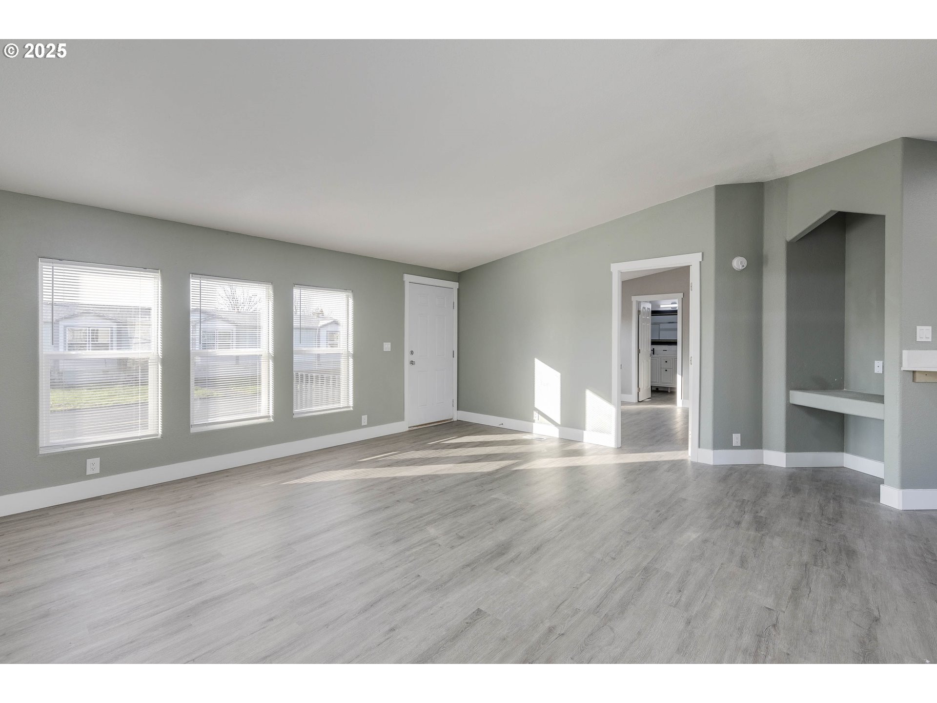 911 York Street, Unit 82 Aumsville, OR 97325 - Photo 6 of 26 a view of an empty room with wooden floor and a window