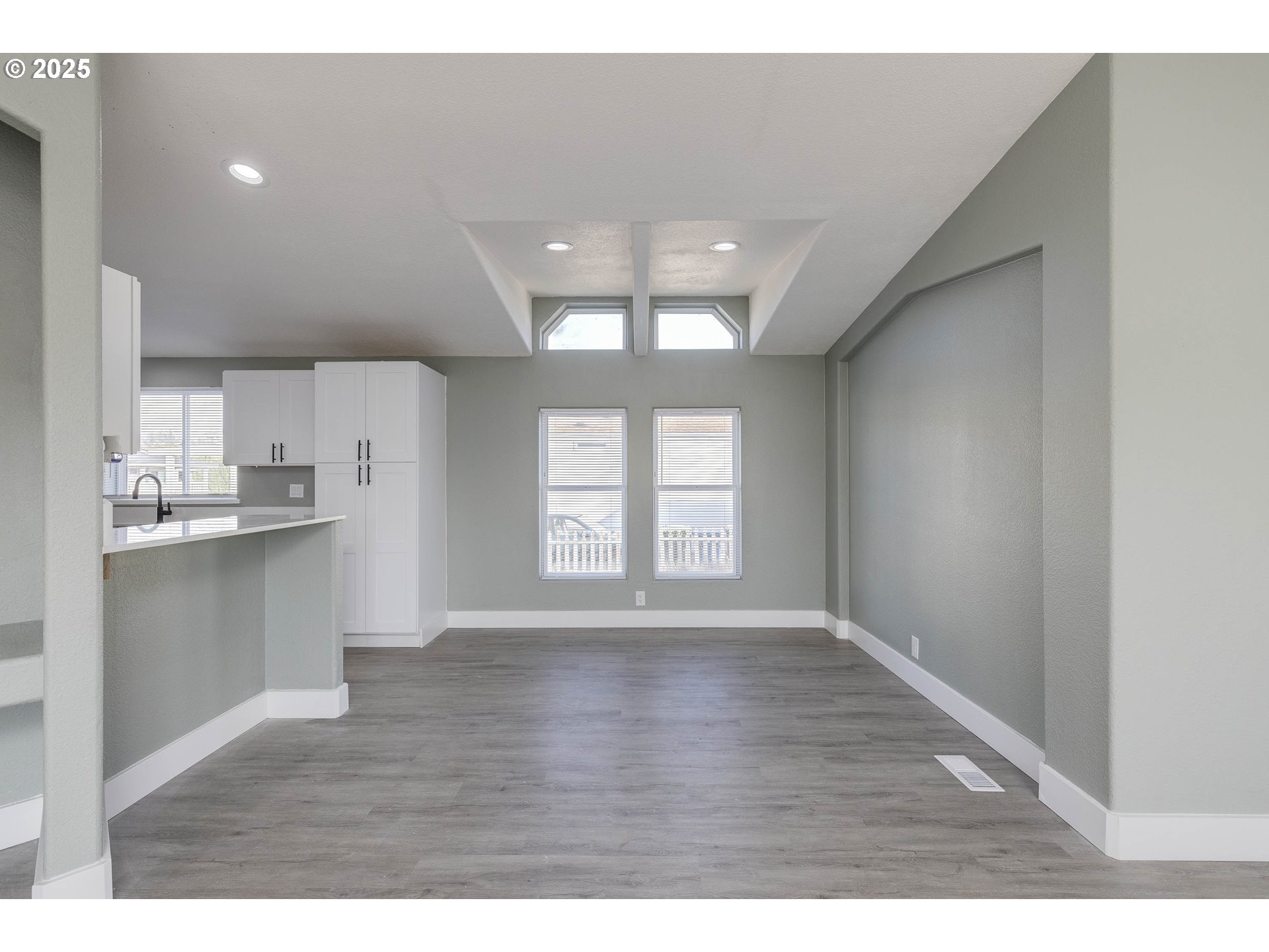 911 York Street, Unit 82 Aumsville, OR 97325 - Photo 8 of 26 a view of an empty room with window and wooden floor