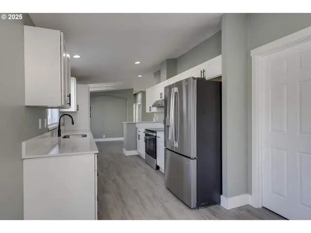 a kitchen with refrigerator and sink